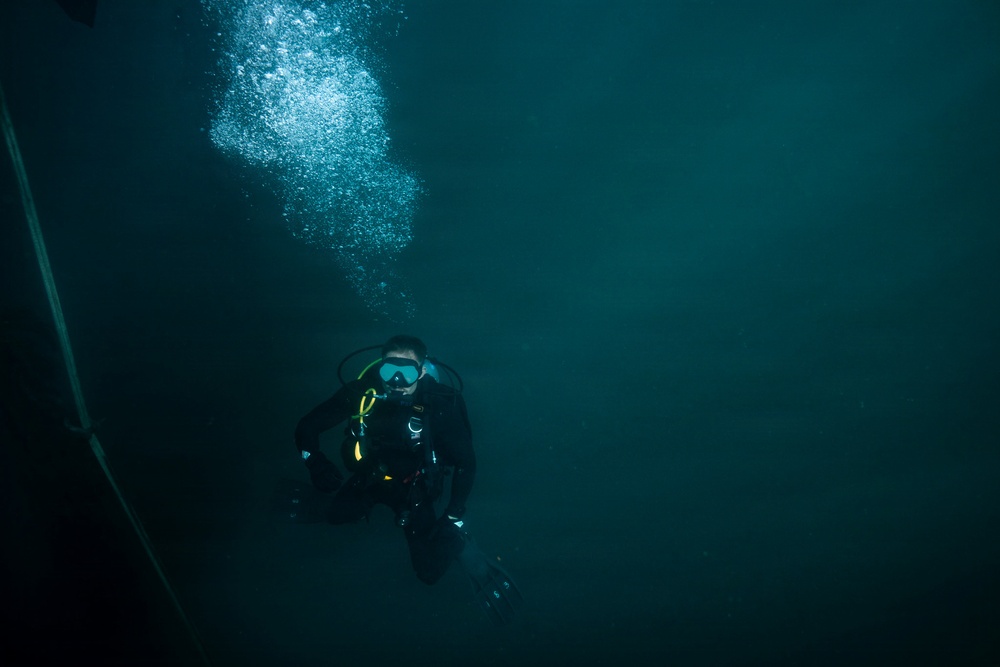 U.S. Coast Guard divers conduct aids to navigation operations