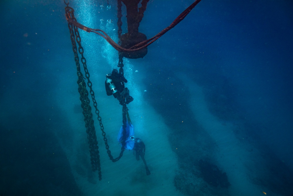 U.S. Coast Guard divers conduct aids to navigation operations