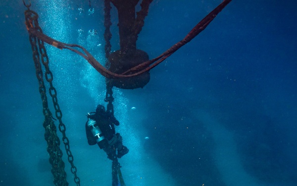 U.S. Coast Guard divers conduct aids to navigation operations