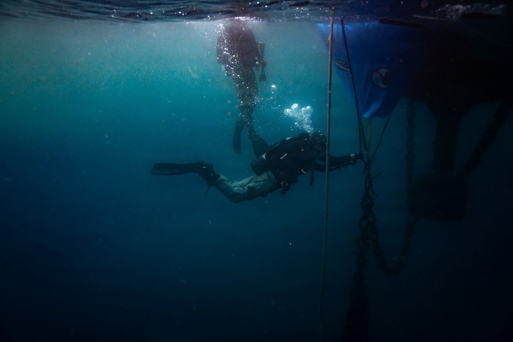 U.S. Coast Guard divers conduct aids to navigation operations