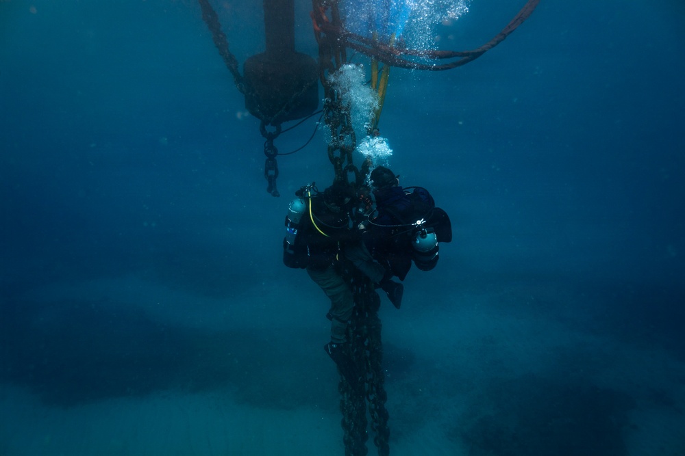 U.S. Coast Guard divers conduct aids to navigation operations