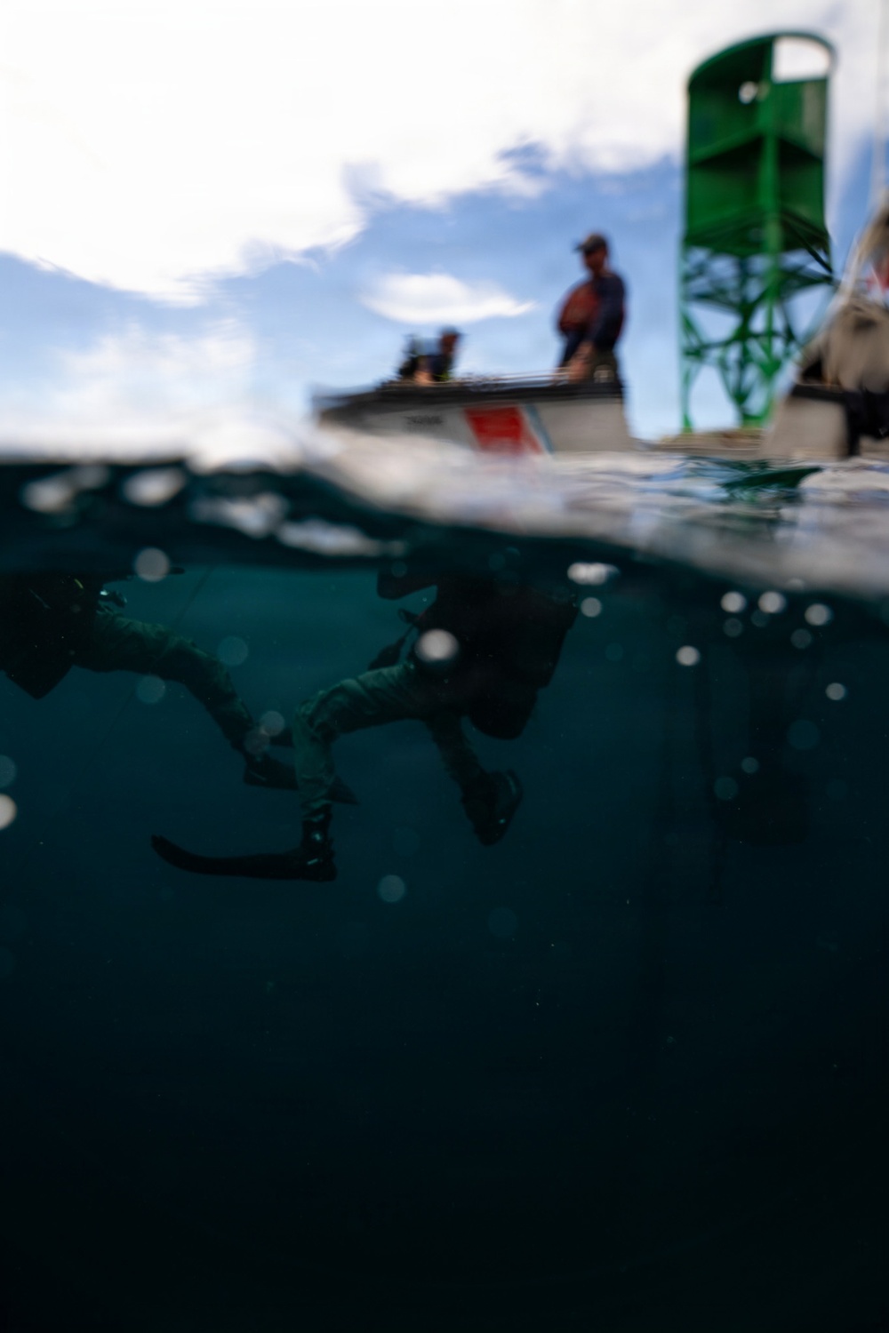 U.S. Coast Guard divers conduct aids to navigation operations