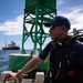 U.S. Coast Guard divers conduct aids to navigation operations