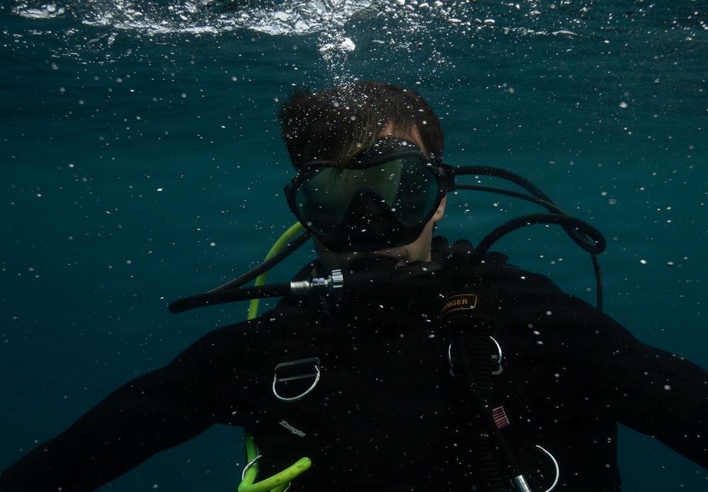 U.S. Coast Guard divers conduct aids to navigation operations