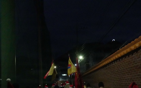 Soldiers ruck through Camp Walker with gifts