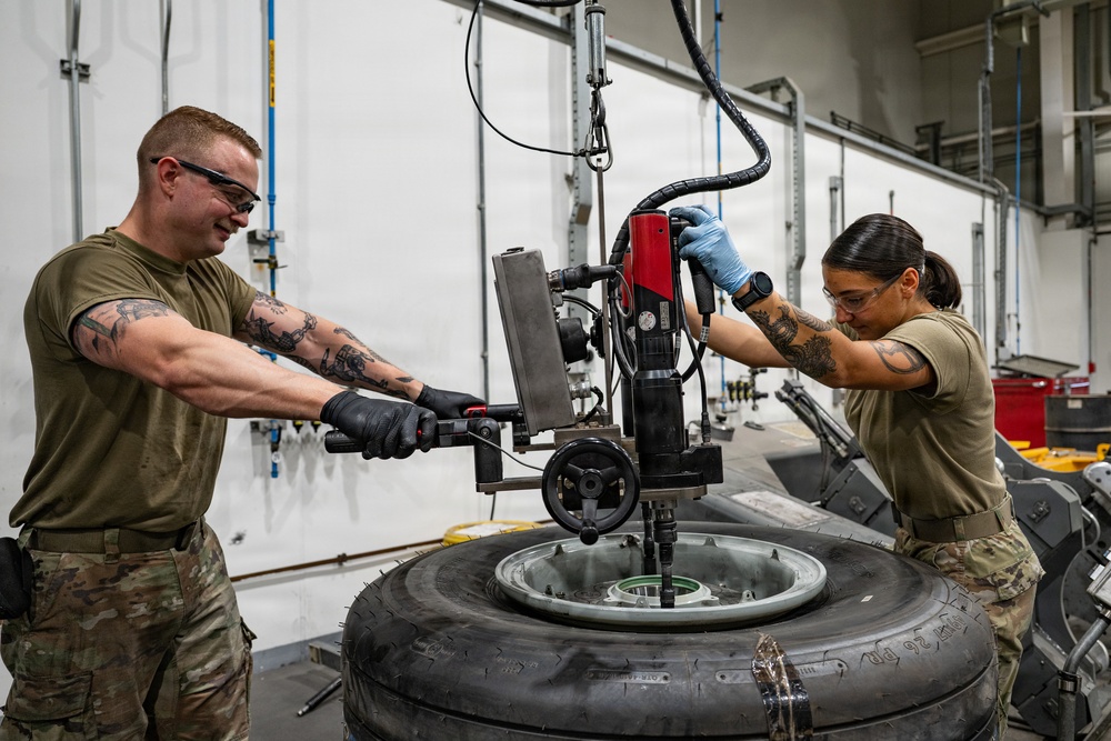 379th Expeditionary Maintenance Squadron maintainers inspect and repair KC-135 Stratotanker aircraft wheel and tire