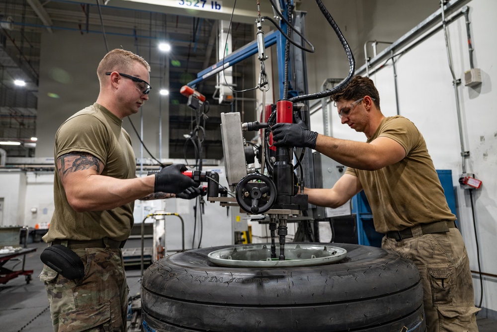 379th Expeditionary Maintenance Squadron maintainers inspect and repair KC-135 Stratotanker aircraft wheel and tire