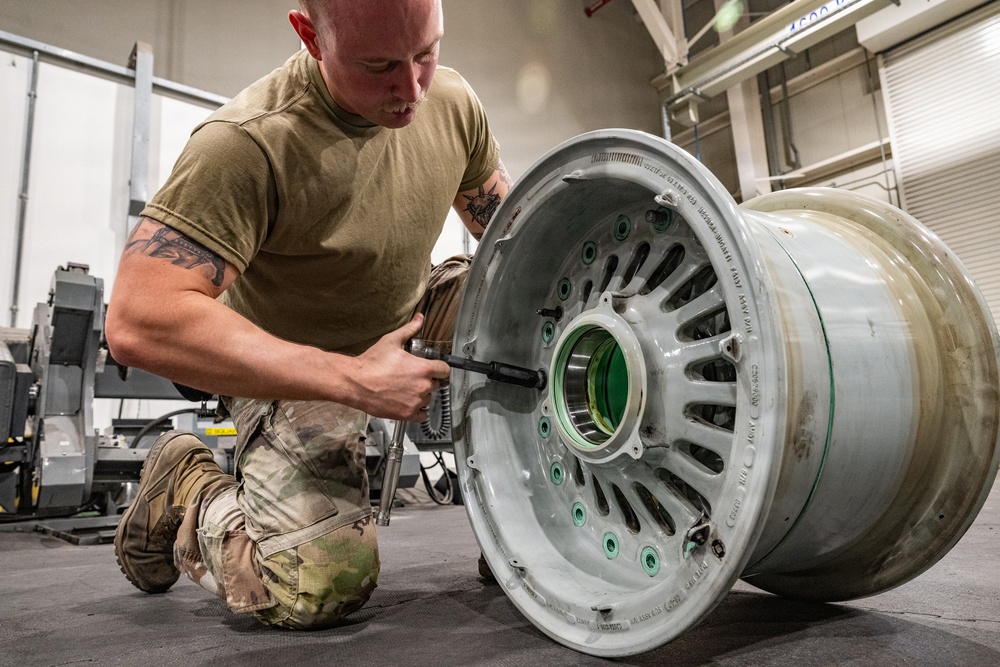 379th Expeditionary Maintenance Squadron maintainers inspect and repair KC-135 Stratotanker aircraft wheel and tire