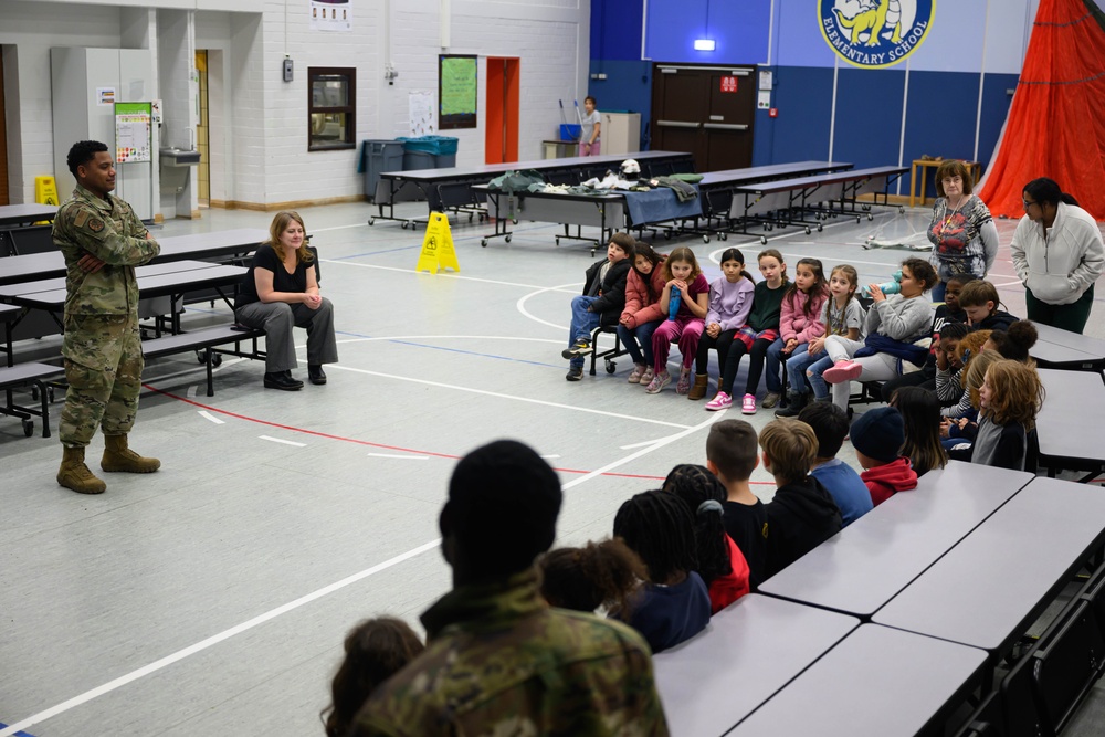 Aircrew flight equipment technicians introduce elementary students to motion, matter with parachutes