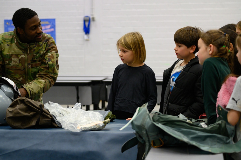 Aircrew flight equipment technicians introduce elementary students to motion, matter with parachutes