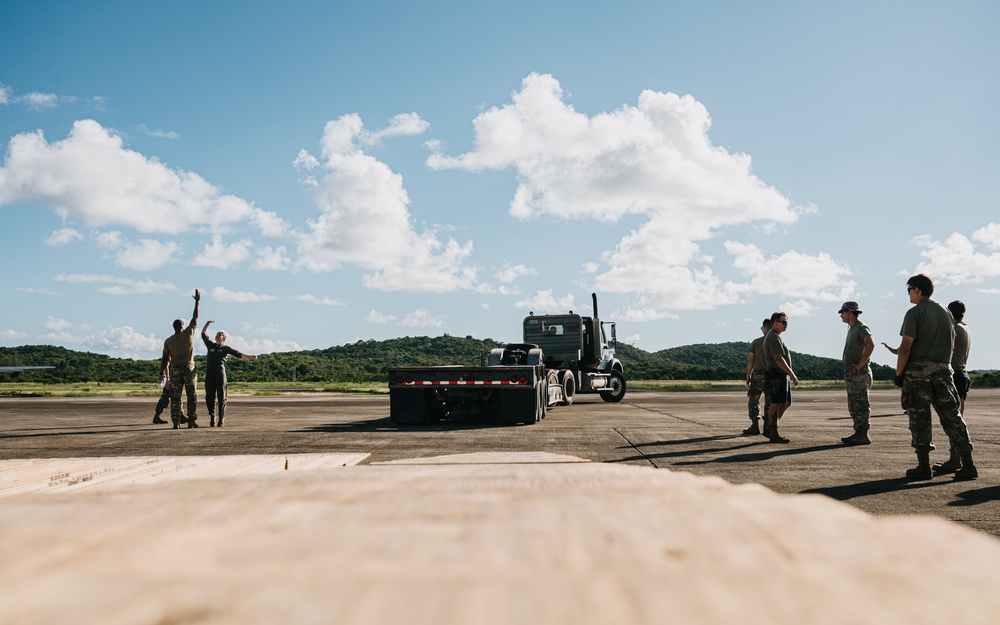 346th AEW offloads lowboy trailer from C-17