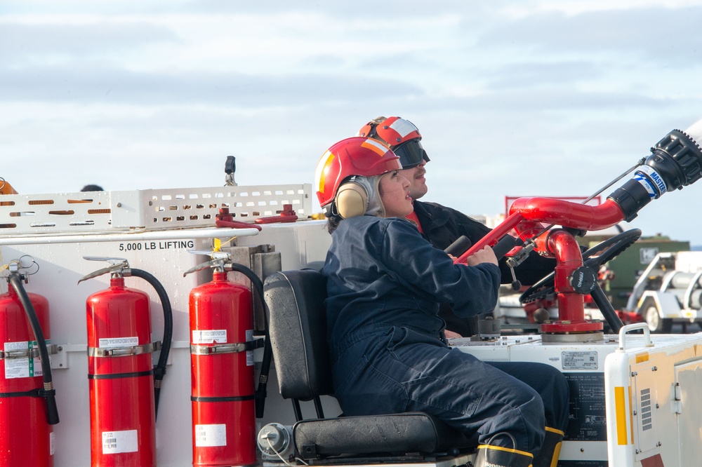 Sailors participate in a counter measure wash down.