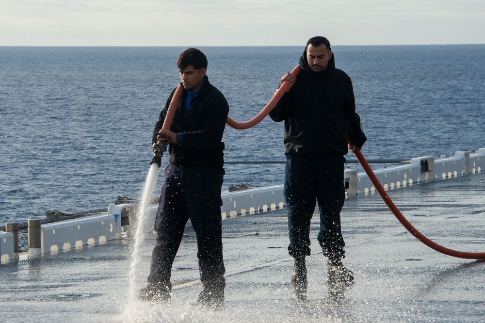 Sailors participate in a counter measure wash down.