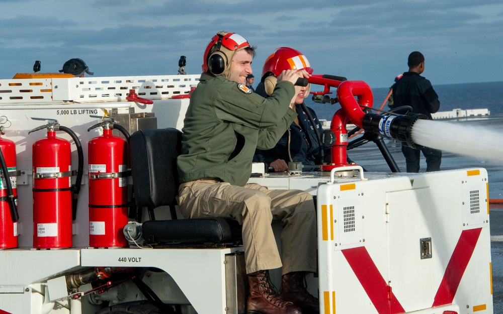 Sailors participate in a counter measure wash down.