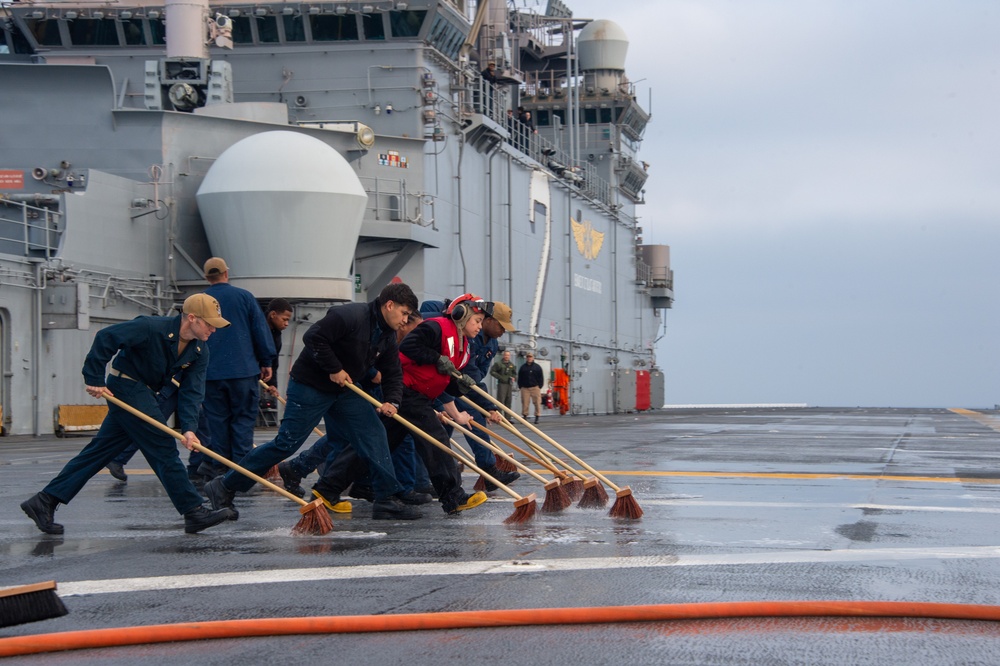 Sailors participate in freshwater wash down.