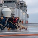Sailors participate in freshwater wash down.