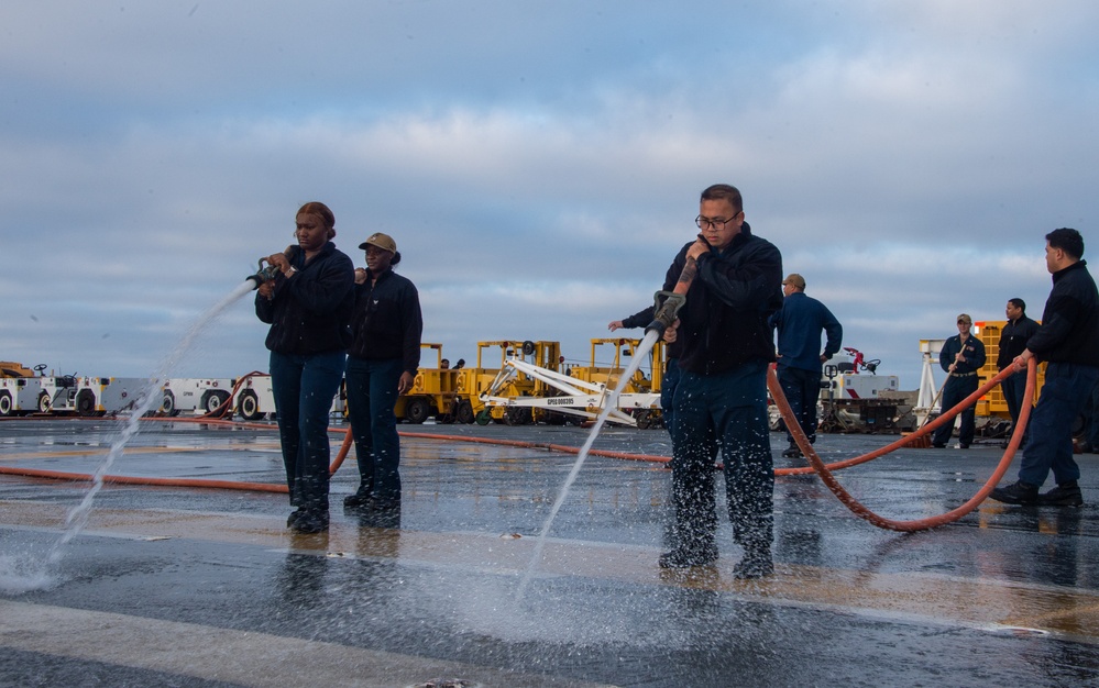 Sailors participate in freshwater wash down.