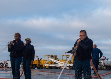 Sailors participate in freshwater wash down.