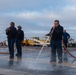 Sailors participate in freshwater wash down.