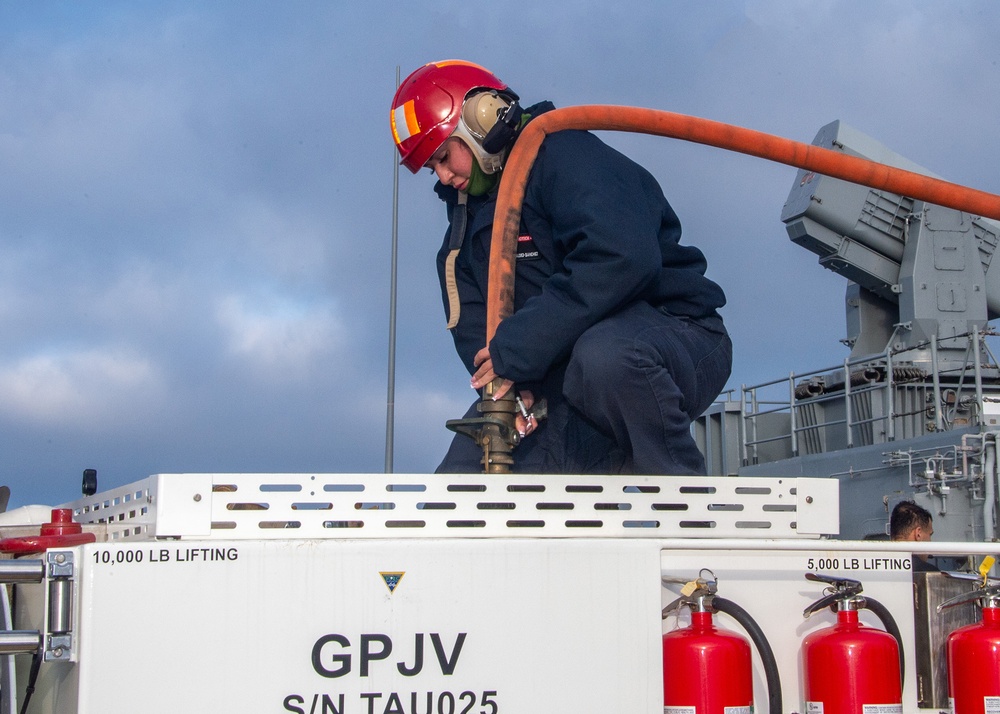 Sailors participate in freshwater wash down.