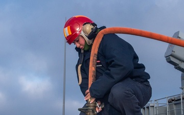 Sailors participate in freshwater wash down.
