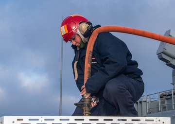 Sailors participate in freshwater wash down.