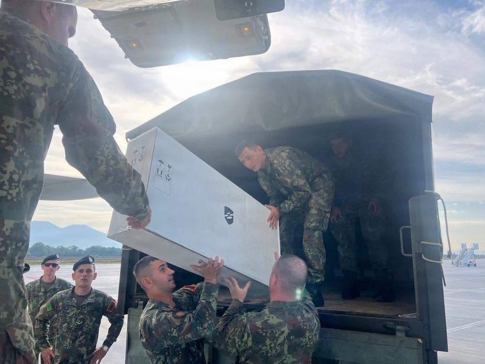 Members of the Albanian Armed Forces receive military equipment from the New Jersey National Guard