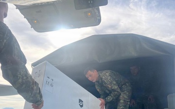 Members of the Albanian Armed Forces receive military equipment from the New Jersey National Guard