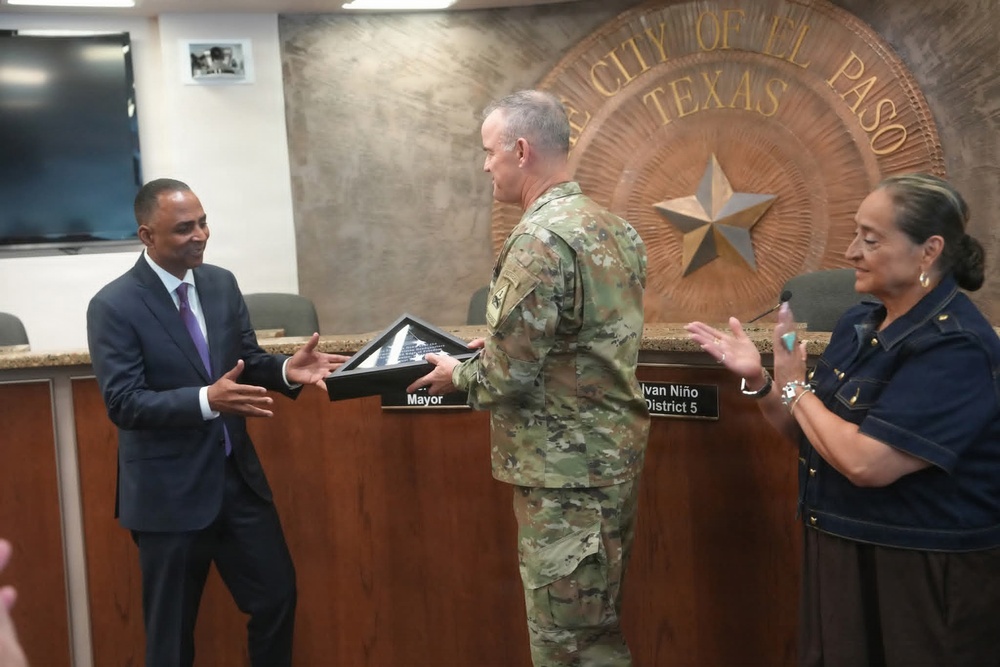 Maj. Gen. Curtis Taylor gives an American flag to the mayor of El Paso