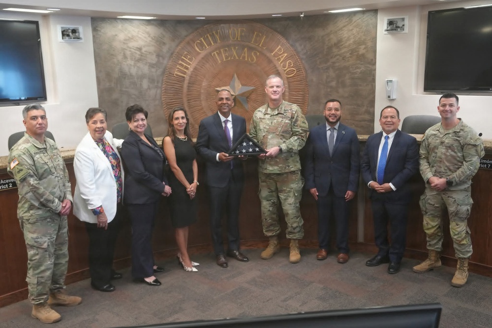 Maj. Gen. Curtis Taylor gives a American flag to the Mayor of El Paso