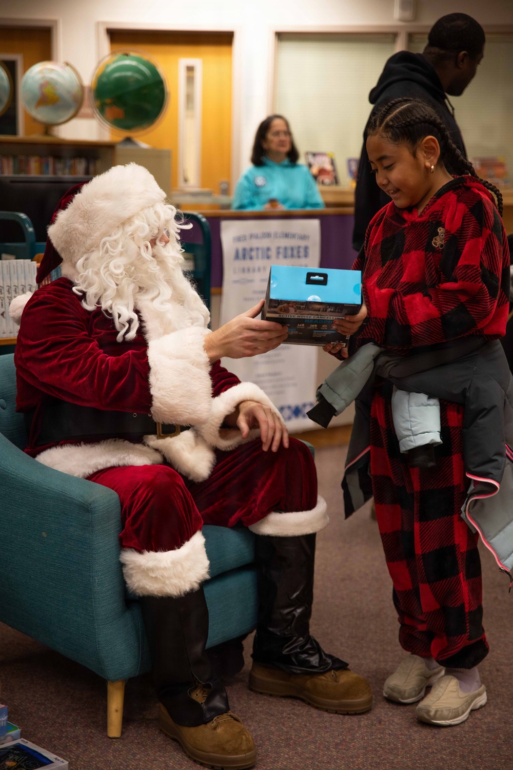 Santa spreads Toys for Tots cheer to students at Fred Ipalook Elementary School