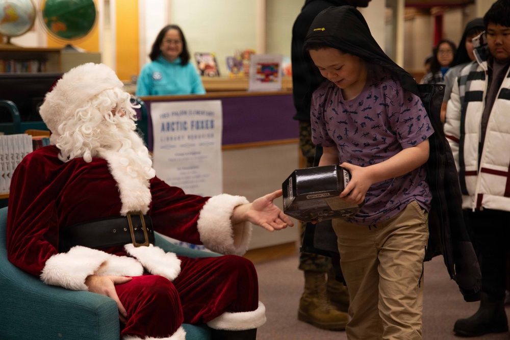 Santa spreads Toys for Tots cheer to students at Fred Ipalook Elementary School