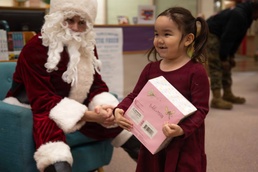 Santa spreads Toys for Tots cheer to students at Fred Ipalook Elementary School
