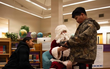 Santa spreads Toys for Tots cheer to students at Fred Ipalook Elementary School
