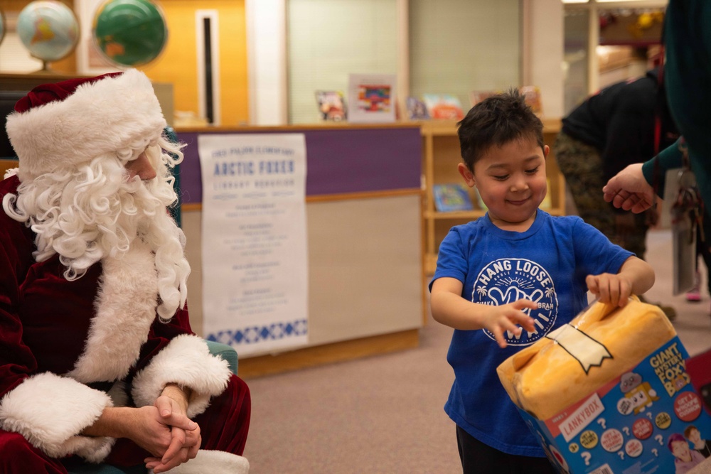 Santa spreads Toys for Tots cheer to students at Fred Ipalook Elementary School