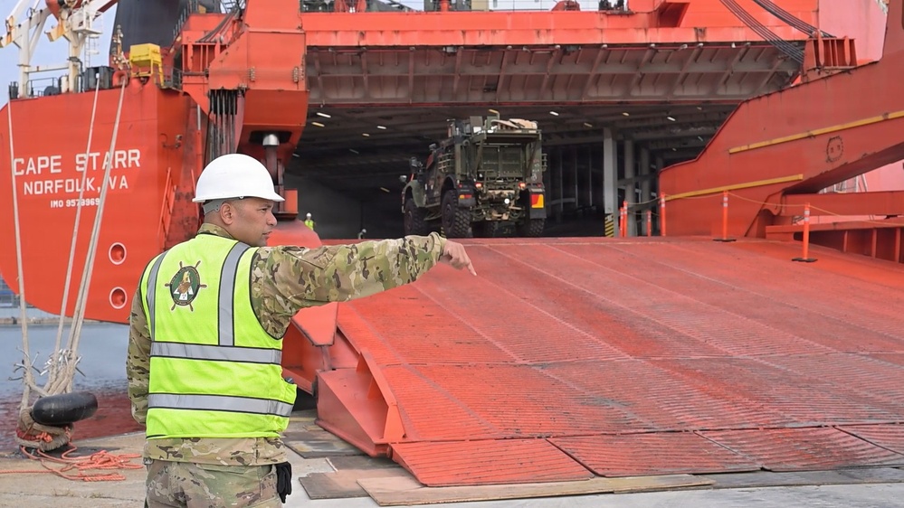 Soldier guides vehicle during offload