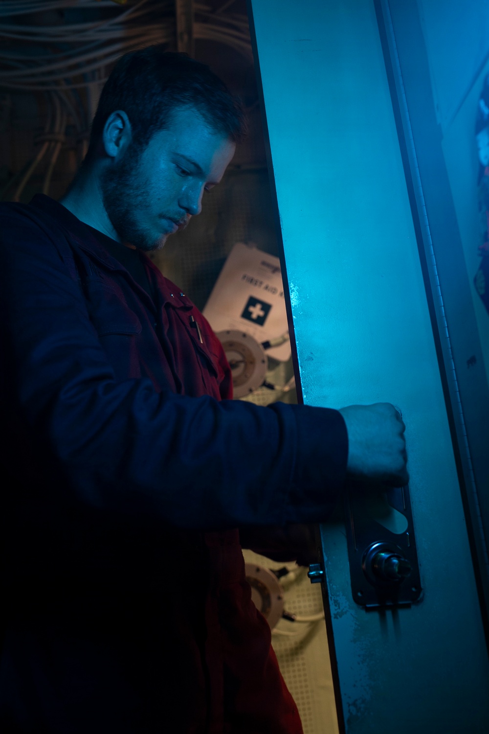 Sailor Repairs Door Aboard USS Tripoli