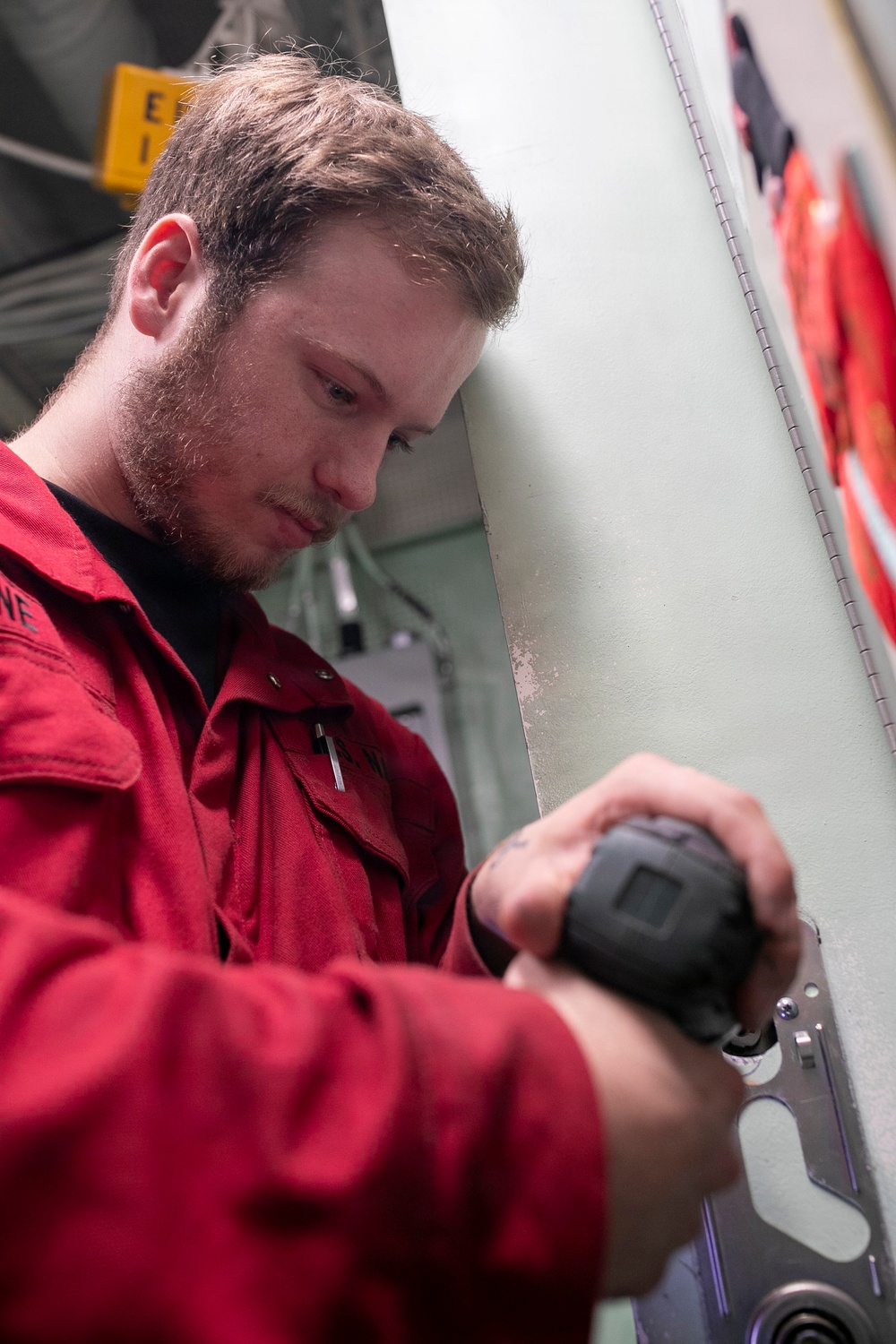 Sailor Repairs Door Aboard USS Tripoli
