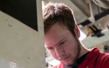 Sailor Repairs Door Aboard USS Tripoli