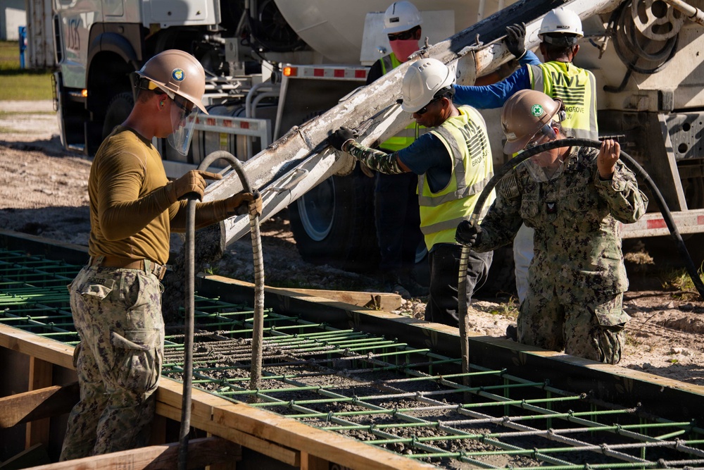 Seabees pour concrete for a Tension Fabric Structure construction project