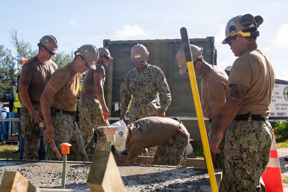 Seabees pour concrete for a Tension Fabric Structure construction project