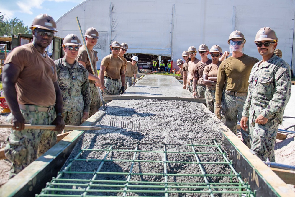 Seabees pour concrete for a Tension Fabric Structure construction project