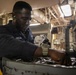USS Mitscher (DDG 57) Sailor secures tools for maintenance in engine room