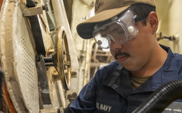 USS Mitscher (DDG 57) Sailor conducts scuttle maintenance