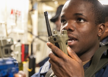 USS Mitscher (DDG 57) Sailor relays information on radio during ATTT drill