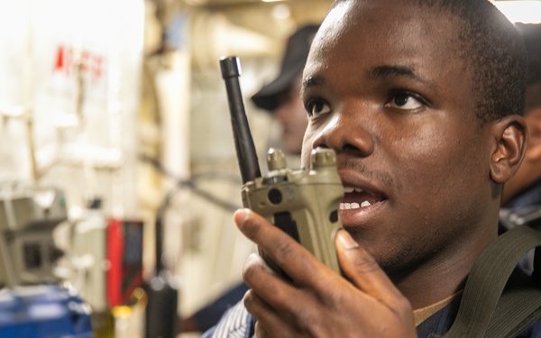 USS Mitscher (DDG 57) Sailor relays information on radio during ATTT drill