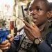 USS Mitscher (DDG 57) Sailor relays information on radio during ATTT drill