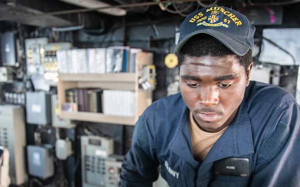 USS Mitscher (DDG 57) Sailor mans helm in ship bridge