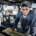 USS Mitscher (DDG 57) Sailor mans helm in ship bridge