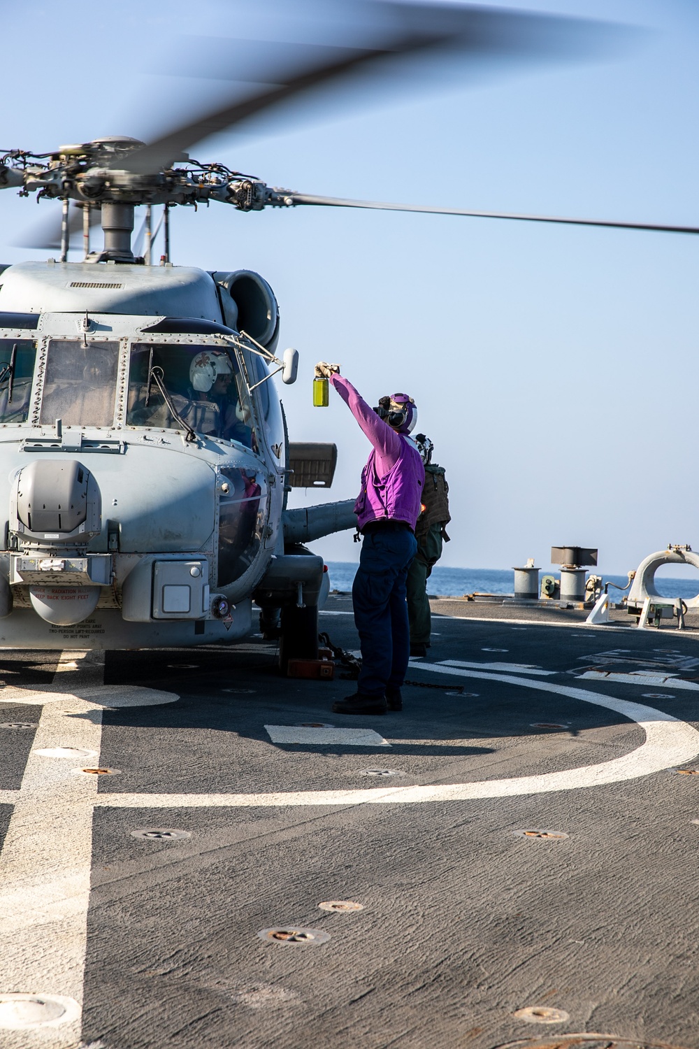USS Mitscher (DDG 57) presents fuel sample to HSM 79 Sea Hawk during flight quarters